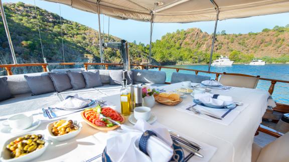 Elegantly laid breakfast table with a view of the sea.