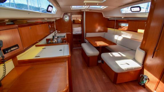 The salon of sailing yacht Zezo offers comfort with a large seating area and a functional galley.