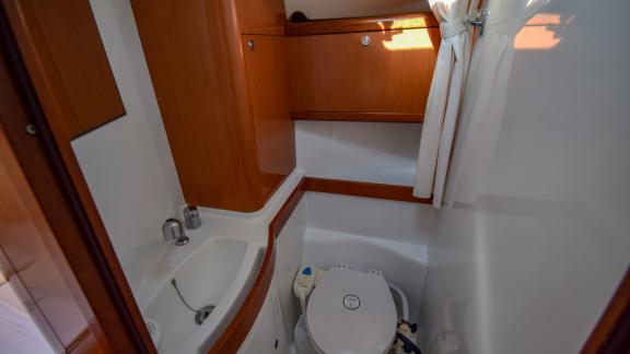 The bathroom of sailing yacht Zezo offers a compact and functional space with a simple design.