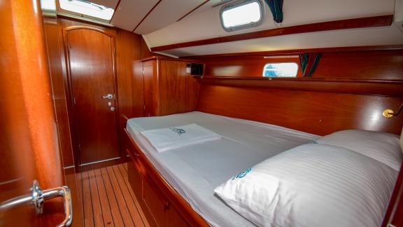 A yacht cabin in a minimalist design. You can see the portholes