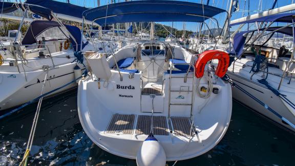 The aft cockpit of the sailing yacht Burda docked in the marina, equipped with safety gear.