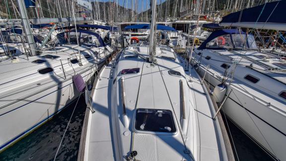 The spacious foredeck of the sailing yacht Burda docked in the marina, surrounded by other yachts.