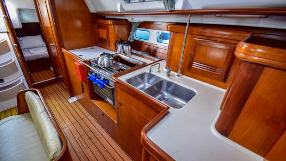 The kitchen of the sailing yacht Burda is equipped with all necessary appliances, such as a double sink and stove.