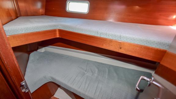 The bunk bed cabin of the sailing yacht Burda offers a compact and functional space with two beds.