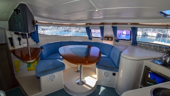 The saloon on Andromeda catamaran features a spacious seating area with views through large windows.