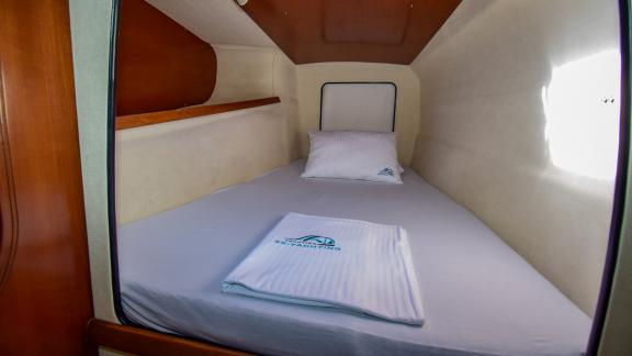 This cabin on the Andromeda catamaran offers a comfortable bed and enough space for basic needs.