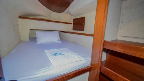 This cabin on the Andromeda catamaran features a spacious bed and convenient storage spaces.
