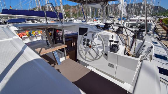 The modern helm area of the Coco D catamaran is equipped with comfortable seating and control panels.