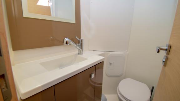 The bathroom of catamaran Coco D offers a modern design and practical amenities for comfort.