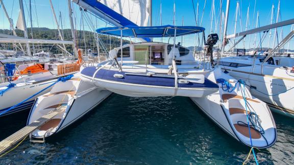 Andromeda catamaran docked at the marina, surrounded by other boats.