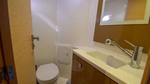 The bathroom of catamaran Coco D features a stylish sink and a compact toilet.