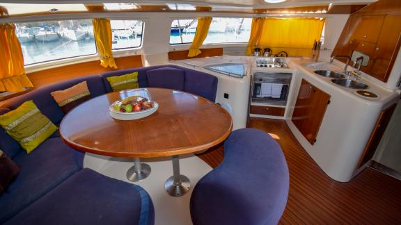 The salon and kitchen of the catamaran The Big Easy offer a spacious seating area and a fully equipped kitchen.