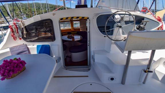 Helm station of the catamaran The Big Easy with marina view and simple design.