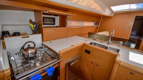 The kitchen of the yacht Instant Zero features an oven, stove, and ample counter space.