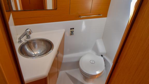 The bathroom of the yacht Instant Zero is equipped with a modern sink and toilet.