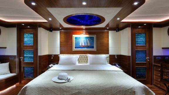 Spacious bedroom gulety in a new stylistic solution. You can see a king size bed and a picture