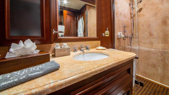 Elegant bathroom on SY Voyage with modern sink, large mirror, and shower.