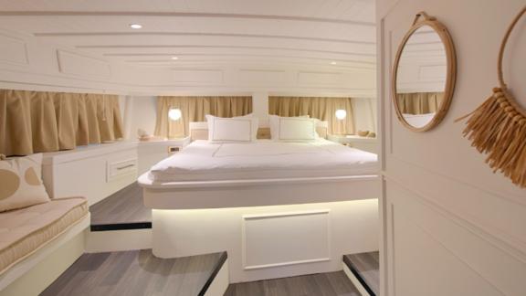 The spacious master cabin on Liberte 11 features a comfortable bed and stylish details.