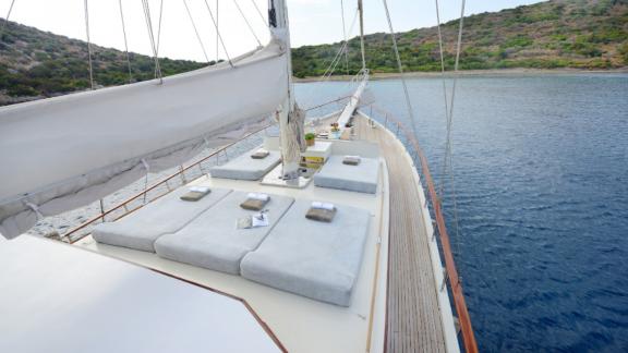 The deck of Gulet Liberte 11 features comfortable sunbathing cushions overlooking the sea.