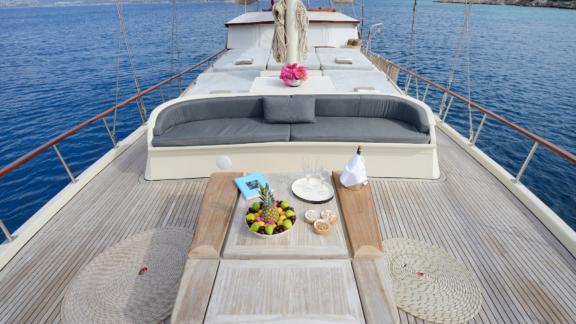The deck of Gulet Liberte 11 features an elegant seating area with sea view and refreshments.