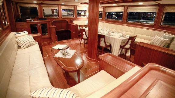 Luxurious interior of Gulet Nurten A with cozy seating areas and an elegant dining table.