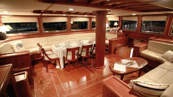 Stylish dining area of Gulet Nurten A with elegantly set table and cozy ambiance.