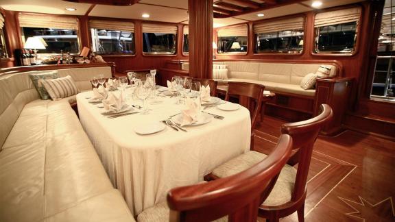 The elegantly set dining table blends perfectly with the luxurious interior of the gulet Nurten A.