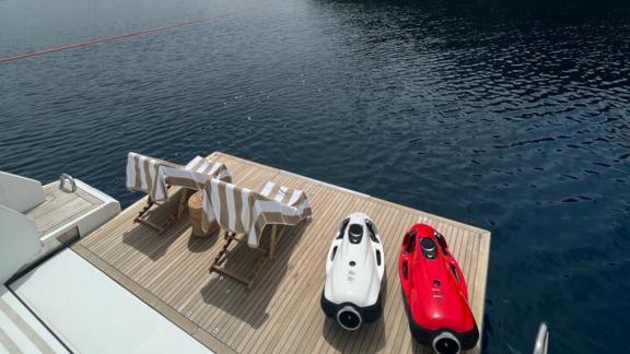 At the aft deck of yacht Nino, water toys and a sunbathing area offer enjoyment by the sea.