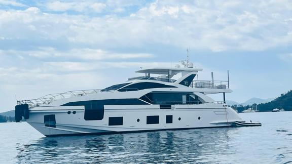 The luxurious motor yacht Nino in calm waters, featuring an elegant design and spacious deck.