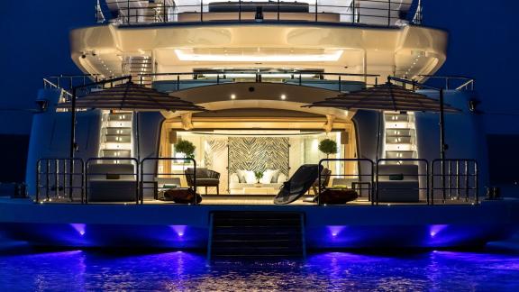 Luxury yacht Opari at night with elegant lighting and an open lounge area.