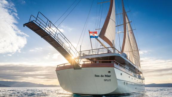 Моторная яхта Son de Mar в Сплите на закате, демонстрирующая элегантный вид с кормы и паруса.