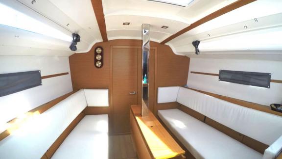 The bright saloon of Sarita features spacious seating and wooden accents.