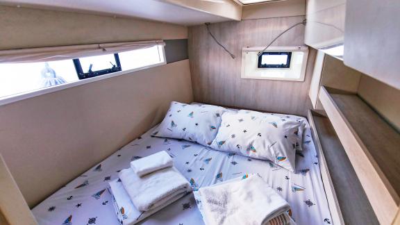 The double cabin on catamaran Deniz3 offers a cozy space with a comfortable bed and natural light.