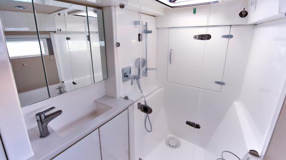 The bathroom on catamaran Deniz3 offers comfort with its modern design and spacious shower.