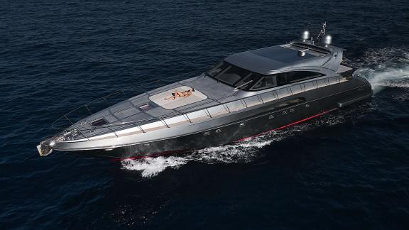 Die Yacht Zazzazu fährt bei Ibiza, ein Gast genießt die Sonne vorne. Ideal für luxuriöse Yachtcharter.