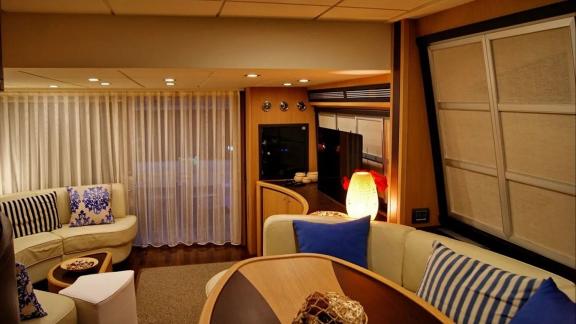 Inside Noi Quattro in Trogir, sofas, table, curtains and warm saloon lighting are seen for yacht charter.