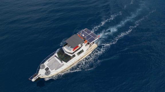 Top view of motor yacht Ada Kuzey cruising at sea.