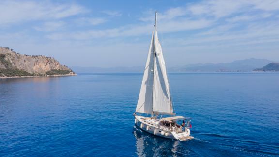 Azra Deniz sailing yacht cruises peacefully on the blue sea.
