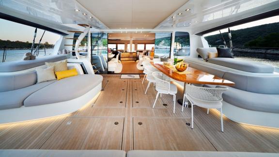 Stylish outdoor area with lounge and dining table on Lagoon Seventy 7, perfect for relaxation.