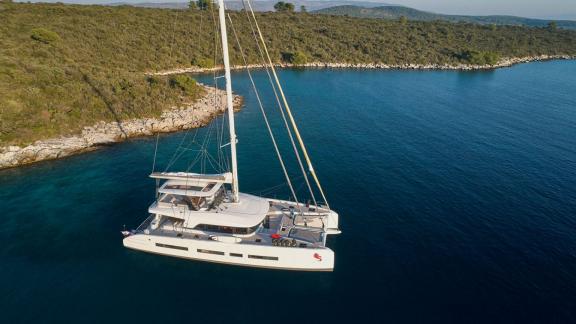 The Lagoon Catamaran Adriatic Dragon anchored off a picturesque coast in Croatia.