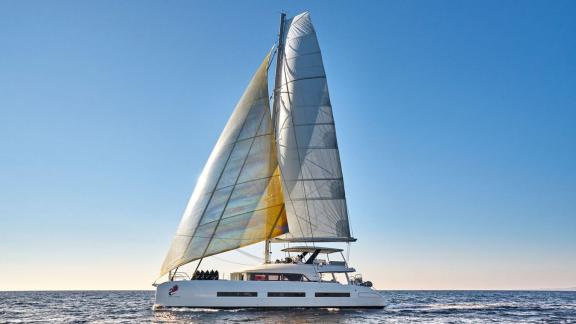 Der Lagoon Katamaran Adriatic Dragon segelt bei klarem Himmel auf offenem Meer.