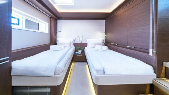 Comfortable twin cabin with two single beds and stylish lighting on Lagoon Seventy 7.