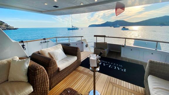 The aft deck of Paula 3 yacht offers a cozy seating area with a sea view.