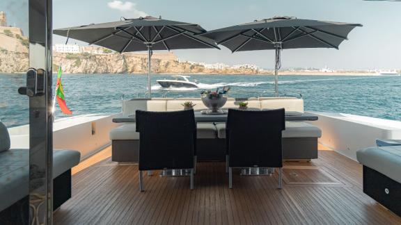 The aft deck of motor yacht La Romana features a spacious and comfortable sunbathing area.