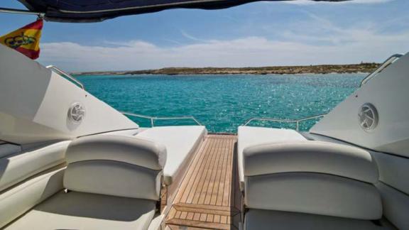 The Lady Boss motor yacht's aft deck features a comfortable sunbathing area with a stunning sea view.