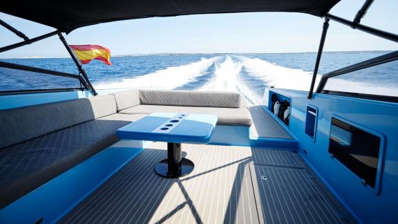 The Blue Steel motor yacht features a rear seating area with a sea view.