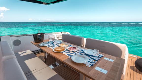 Ein Esstisch auf dem Achterdeck der Motoryacht Endless Summer mit Blick auf das Meer.