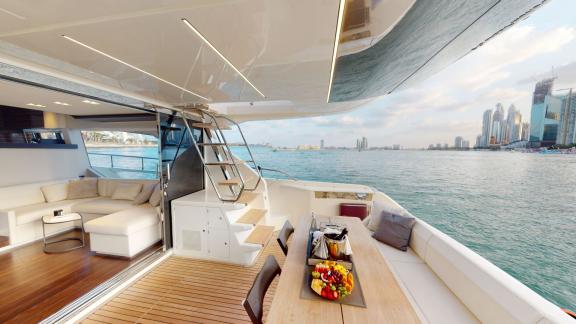 The aft deck of the Ferretti 670 motor yacht adds style and comfort to your daily yacht rental experience in Dubai.