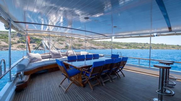 Spacious seating and dining area on the aft deck of Gulet Cemre Junior.