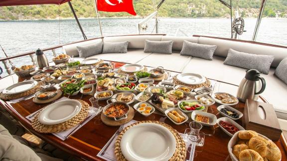 Lavish breakfast spread on Gulet Pronto Blue with a sea view.